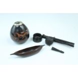 A small group of treen curios including an Irish bog oak miniature cauldron and tripod stand, and