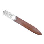 A late 20th Century silver mounted paper knife, the handle being decorated with repousse scrolls and