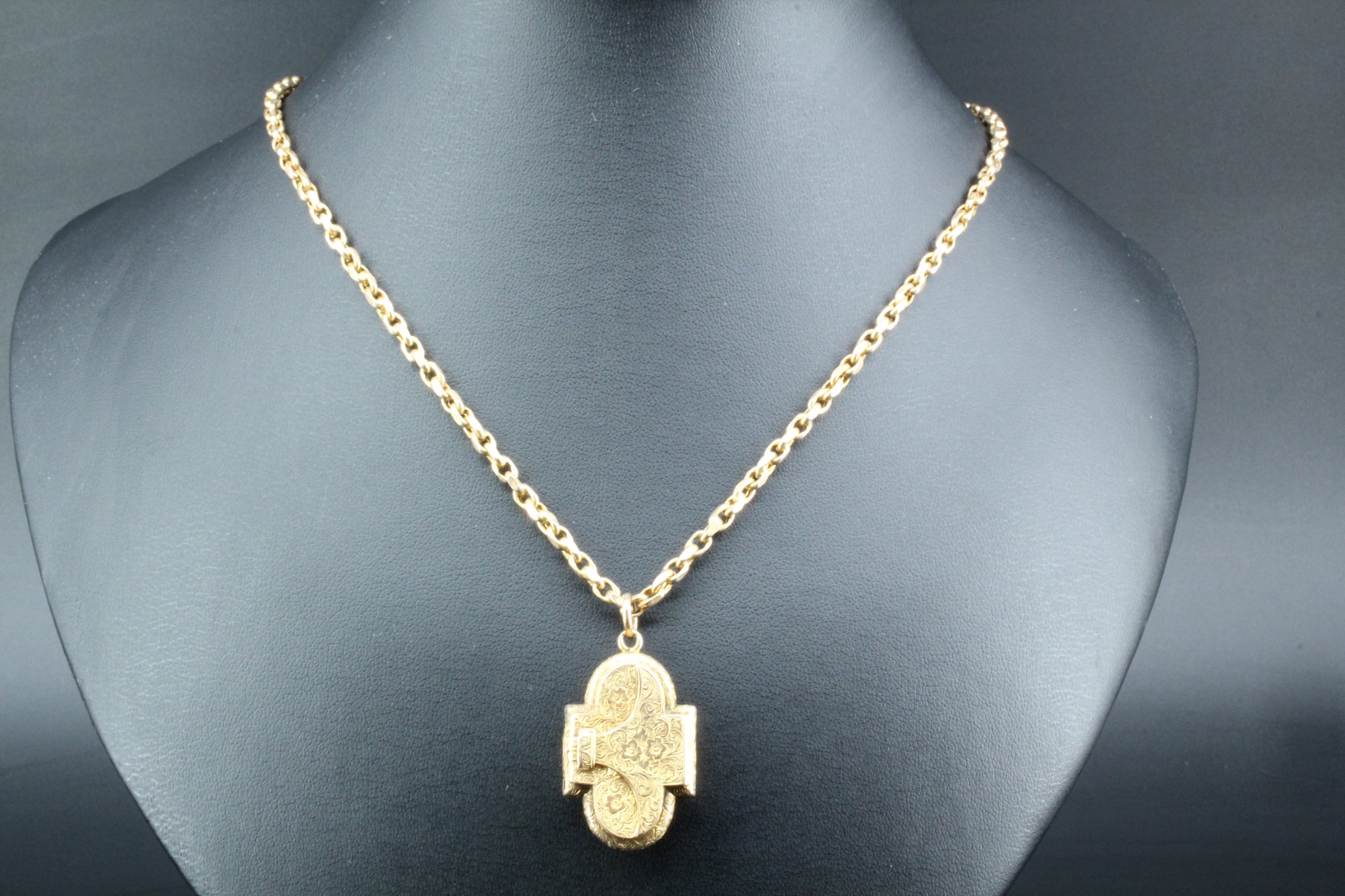 An Edwardian cruciform double locket necklace, the front having double overlapping covers with