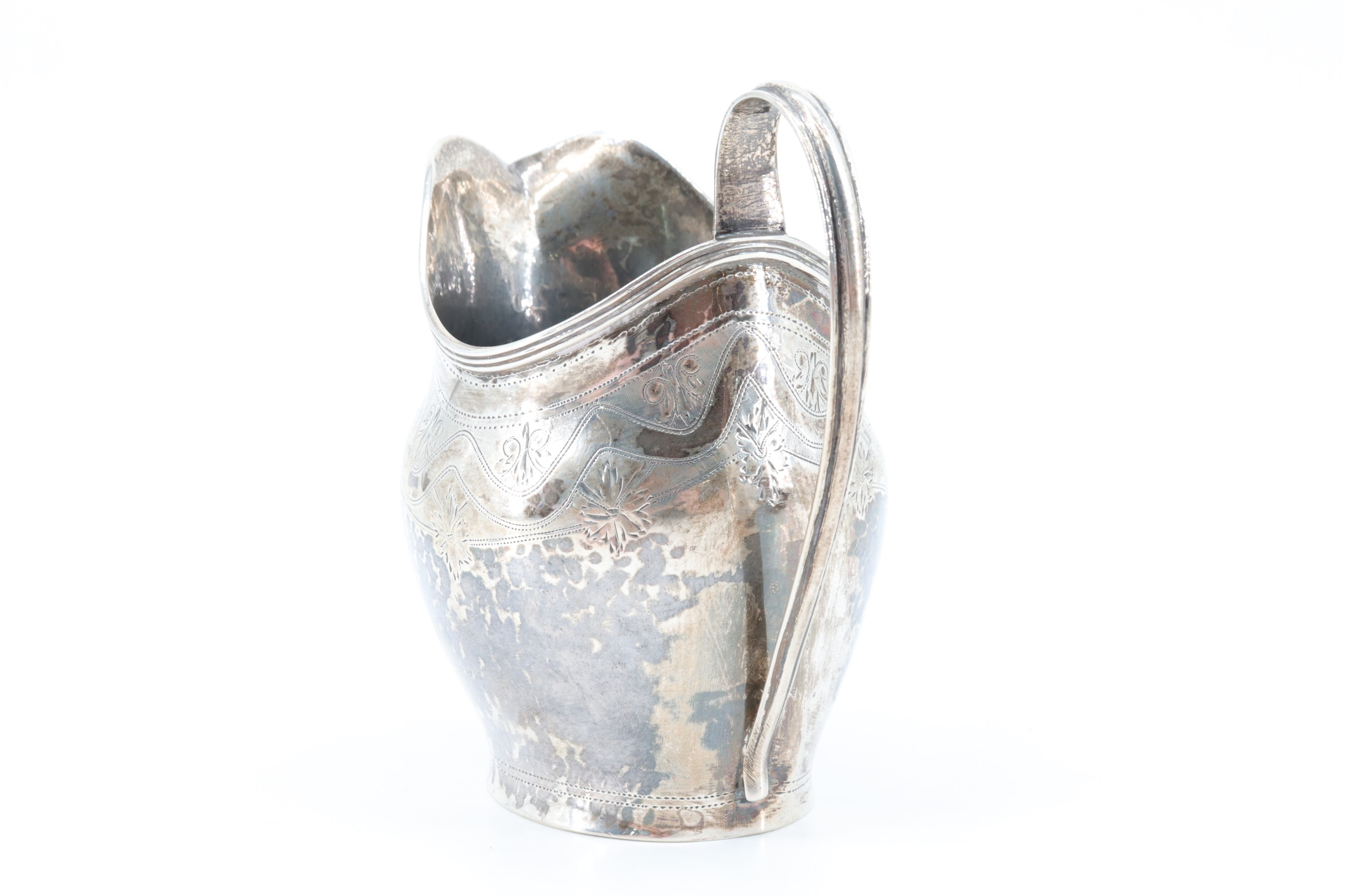 A Georgian silver cream jug, having bright cut decoration and a shield bearing a monogram to the - Image 3 of 4