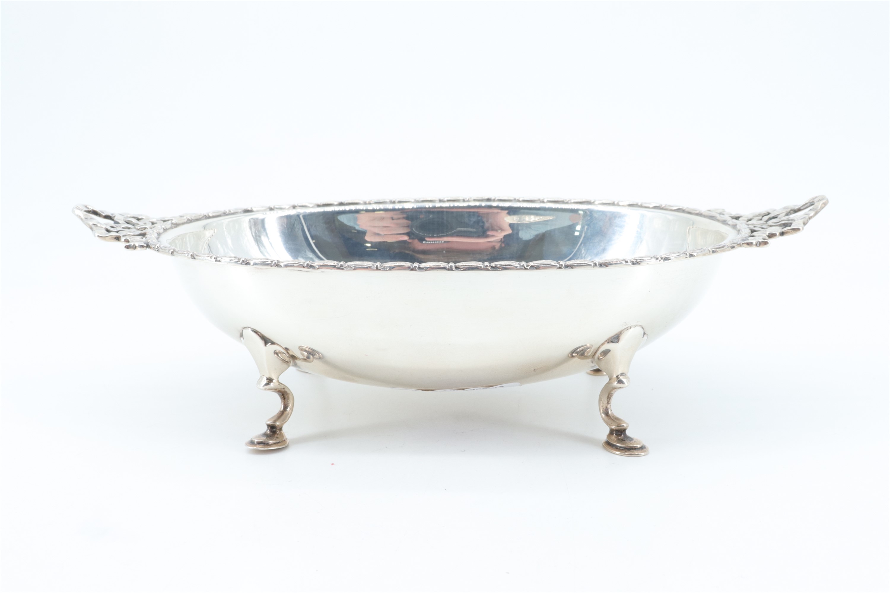 A George III influenced oval silver bowl, having Neoclassical edge moulding and horizontal pierced