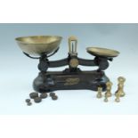 Early 20th Century Boots Cash Chemists branded cast iron and brass kitchen scales, together with