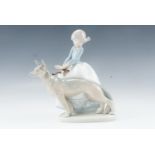 A Lladro figurine girl and dog, boxed, 21 cm