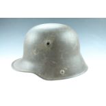 An Imperial German Model 1917 steel helmet, its shell stamped Si.62