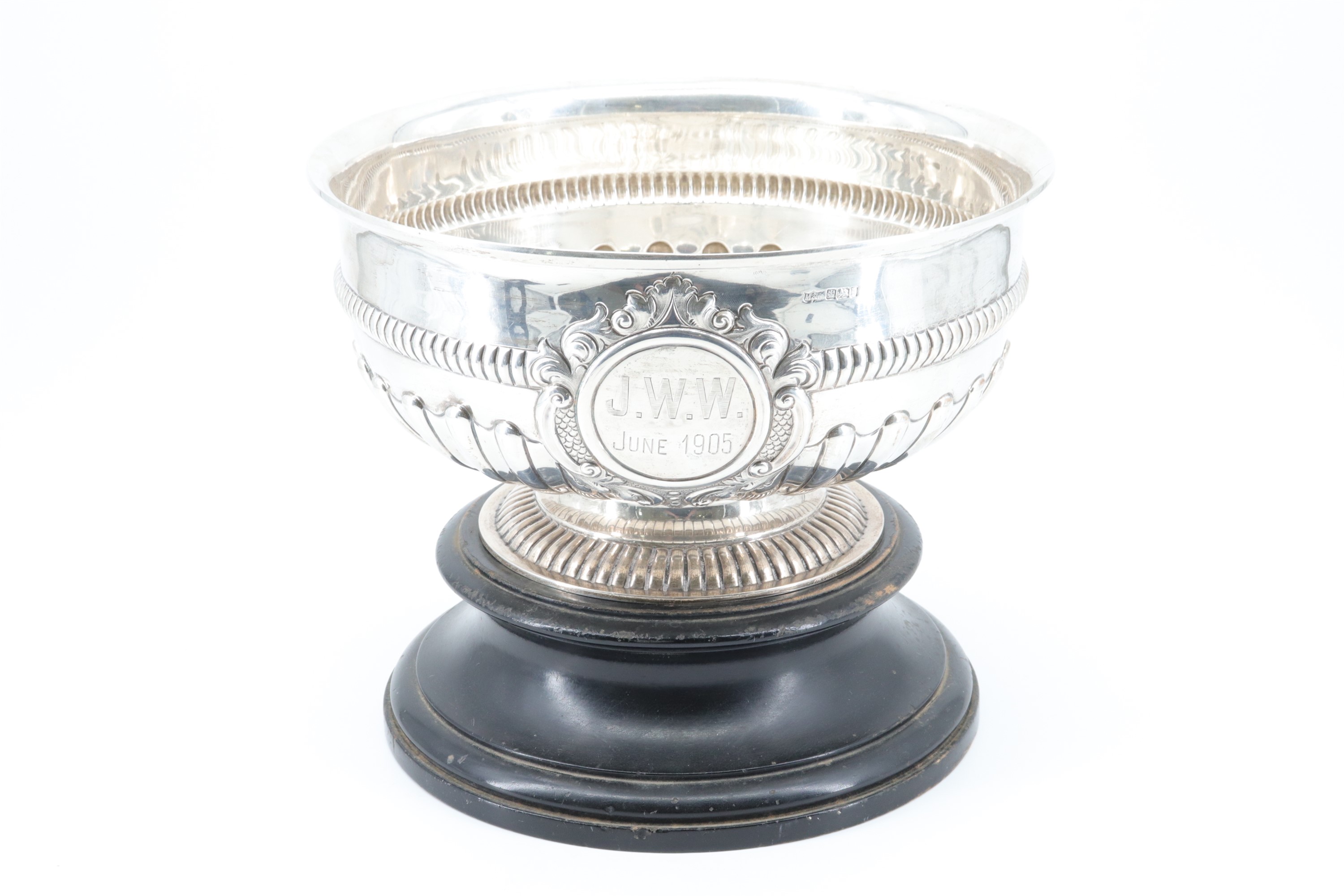 An Edwardian silver punch bowl, decorated with pronounced gadrooning and a ribbed band at its waist,