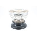 An Edwardian silver punch bowl, decorated with pronounced gadrooning and a ribbed band at its waist,