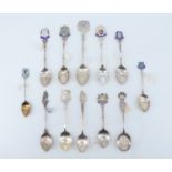 12 silver and enamelled silver souvenir teaspoons, relating to Cornwall including Falmouth, St
