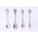 Four Dutch white metal souvenir teaspoons, relating to shipping including "M.S. Willem Ruys", "M.