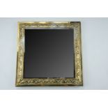 An early 20th Century small brass-framed bevel-edged wall mirror, 33 cm x 33 cm