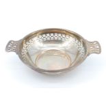 A mid 20th Century pierced silver quaich form bon-bon dish, having a reticulated border around the