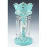 A Victorian turquoise glass lustre, having hand painted enamel and gilt decoration, and eight
