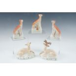 19th Century Staffordshire pottery greyhounds, a pair and a single with hares, together with a