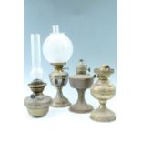 Four brass oil lamps, 52 cm tallest