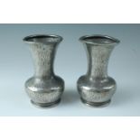 A pair of early 20th Century Tudric pewter vases, each of shouldered form with pronounced flared