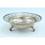A George VI round silver bowl, having a reticulated everted rim with a gadrooned edge, raised on