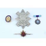 A Berwickshire Veteran Reserve enamelled lapel badge together with a Black Watch cap badge and two