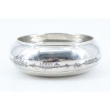 A Middle Eastern white metal and niello bowl, of oblate form with inverted rim, decorated in a