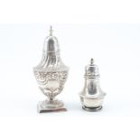 A Victorian baluster shaped silver pepperette, having repousse decoration, raised on a square