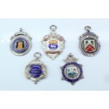 Five 1920s / 1930s silver and enamel football fob medals, comprising "Beckenham Amateur" and "Hendon