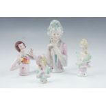 Four late 20th Century porcelain pin cushion ladies, tallest 12 cm