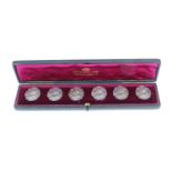 A cased set of six Belle Epoque white metal buttons, bearing a depiction of a young maiden with