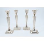 A set of four early 20th Century silver candlesticks, each being of square tapered form with