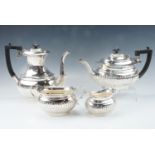 An Edwardian four piece silver tea service, of Georgian form having gadrooned decoration, with