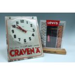 A mirrored promotional clock for Craven 'A' cigarettes, having a white dial with Arabic numerals