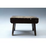 A late 19th / early 20th Century scumbled pine milking stool, 30 cm x 18 cm x 21 cm