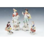 A pair of Sitzendorf early 20th Century Rococo influenced porcelain figurines of a lady and