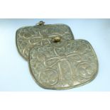 A pair of early 20th Century Japanese brass pendant plaques, relief decorated incorporating mon,