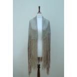 A vintage silver and pale celadon green brocade fringed shawl, decorated in an abstract pattern of
