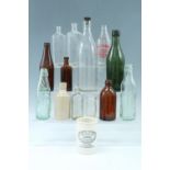 A small collection of glass bottles including a Merthyr Bottling Co Codd patent mineral water