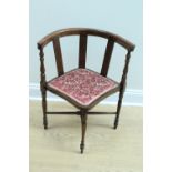 A late 19th / early 20th Century horseshoe-back corner armchair