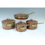 A graded set of copper pans, a copper kettle, Victorian brass pan etc