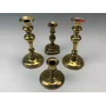 A pair of Victorian brass inverted baluster candlesticks, together with a Georgian brass candlestick