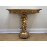 A near contemporary glass-topped gilt resin console table