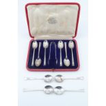 A cased set of Scottish Art Deco silver teaspoons and tongs, having tapering handles and convex