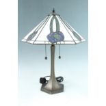 A contemporary Art Nouveau style table lamp, having a bronzed base of flared form and polygonal