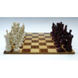 A resin Napoleonic Wars themes chess set, King's 13 cm, together with a wooden chess board