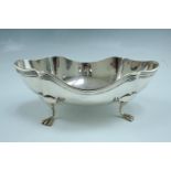 A 1920s silver bowl, of scalloped navette form with a reed moulded edge, raised on four curved feet,