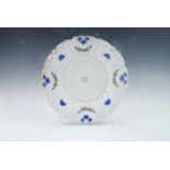 A late 19th Century moulded and enamelled Baroque revival plate, bearing underglaze painted