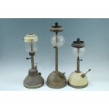 Two Tilley lamps and a Bi Alladin lamp, tallest 53 cm