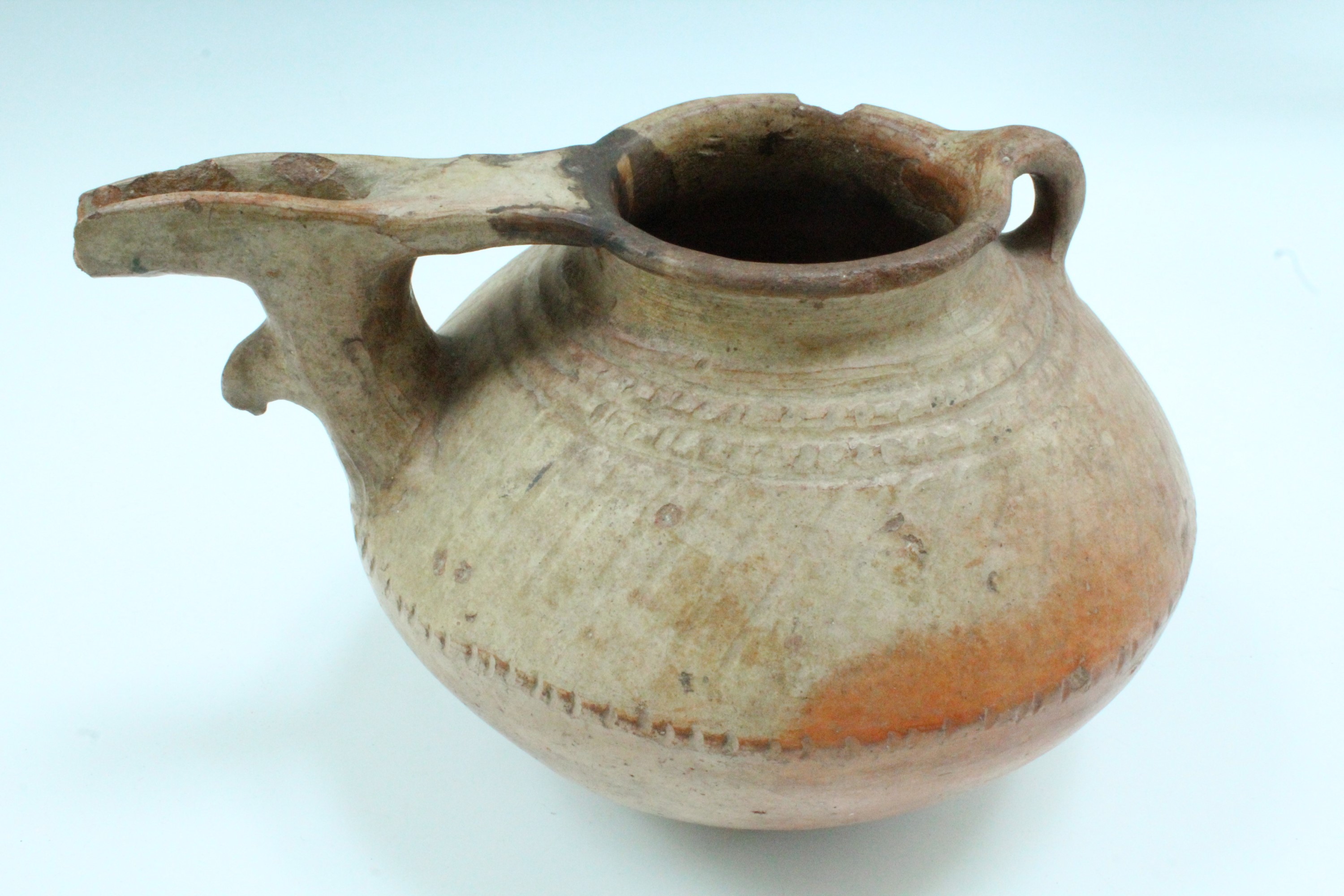An ancient Luristan earthenware spouted vessel, of lenticular form with bridged spout and opposed - Image 3 of 4