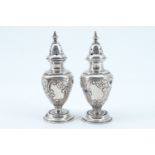 A pair of Edwardian silver pepper pots, bearing chased foliate decoration, 67 g