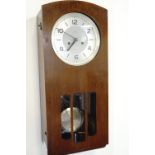 An Enfield Art Deco influenced walnut wall clock, having a silvered dial with Arabic numerals and