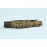 An antique pocket folding knife, its handle carved in depiction of a woman, 14 cm