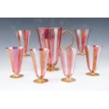 A flamboyant 1950s free blown glass lemonade set, comprising six bell form and pink striped