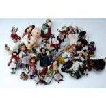 A quantity of composition national dress dolls together with a mid 20th Century bath / squeaky toy