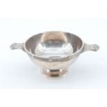 A late 20th Century silver quaich, the horizontal lug handles and rim having Celtic influenced